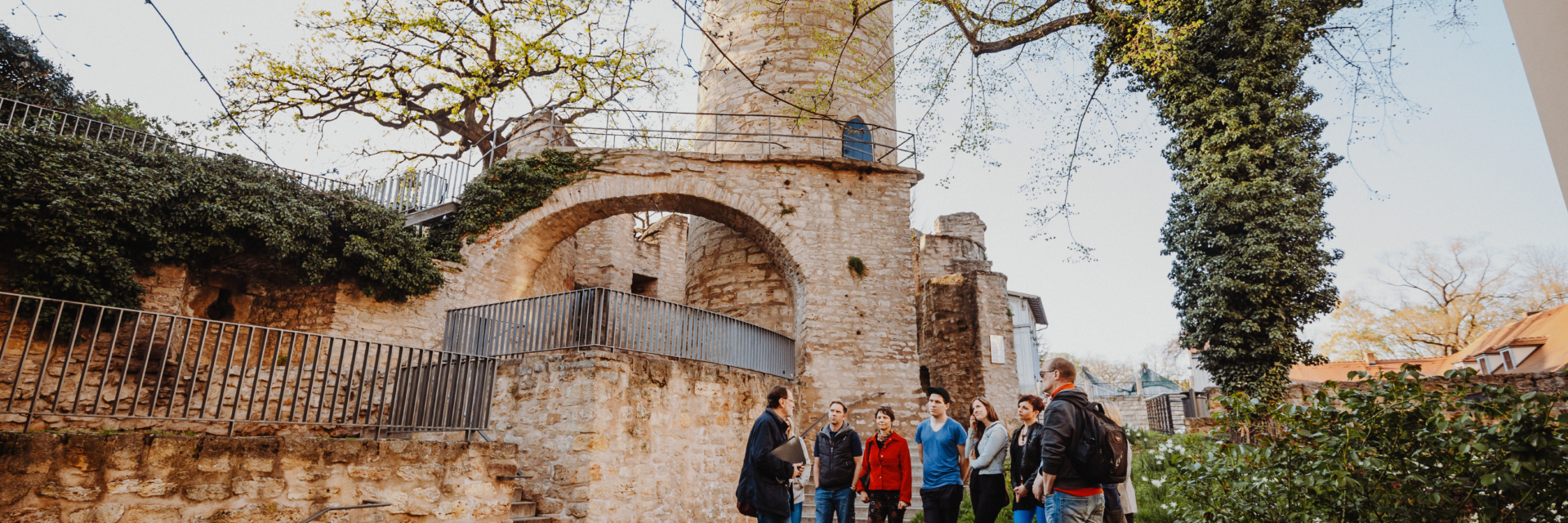 Eine Personengruppe bei einer Stadtführung durch Jena steht vor dem Pulverturm©JenaKultur_Siomotion